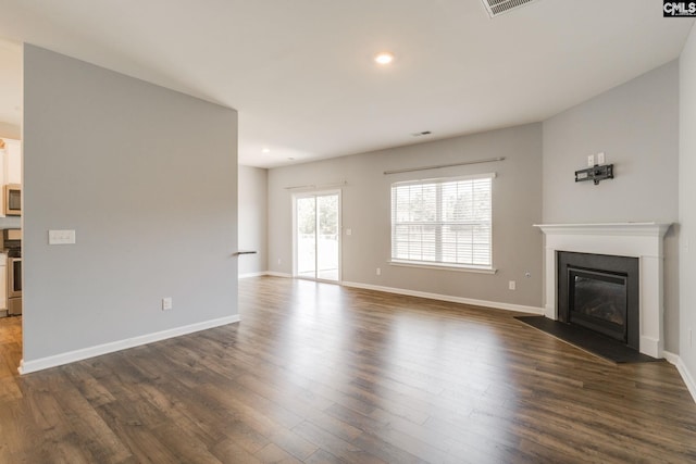 724 Channing Creek Ln, Lexington, SC 29072 - unfurnished living room with dark wood-type flooring, a fireplace with flush hearth, baseboards, and recessed lighting