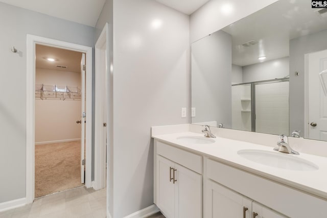 724 Channing Creek Ln, Lexington, SC 29072 - bathroom with double vanity, a walk in closet, a stall shower, and baseboards