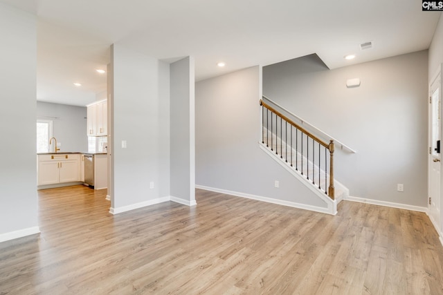 724 Channing Creek Ln, Lexington, SC 29072 - unfurnished living room with stairway, light wood-style flooring, a sink, baseboards, and recessed lighting