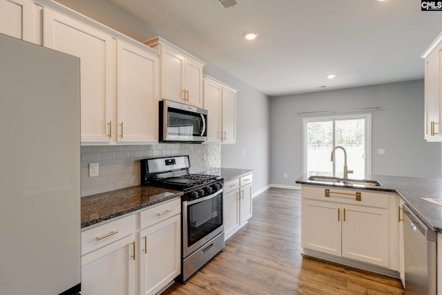 724 Channing Creek Ln, Lexington, SC 29072 - kitchen with appliances with stainless steel finishes, a sink, tasteful backsplash, white cabinets, and recessed lighting