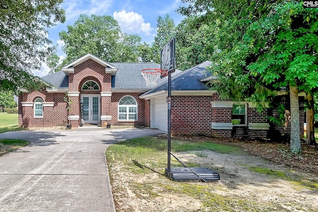 117 Shoal Creek Ln, Blythewood, SC 29016 - view of front of home featuring french doors, driveway, brick siding, roof with shingles, and an attached garage