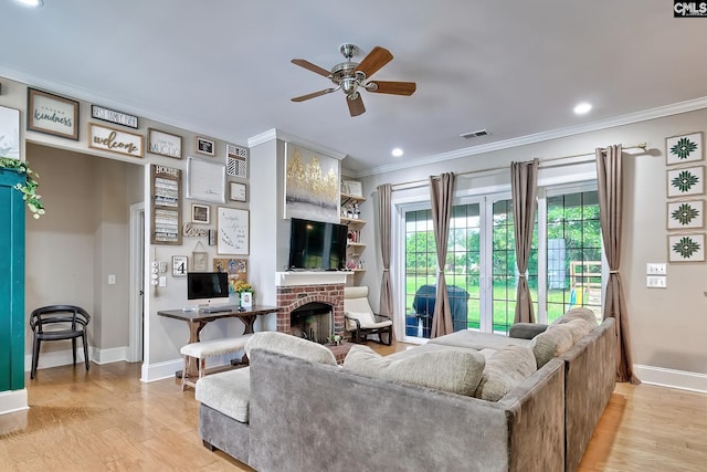 117 Shoal Creek Ln, Blythewood, SC 29016 - living room featuring ceiling fan, baseboards, crown molding, light wood-style floors, and a brick fireplace