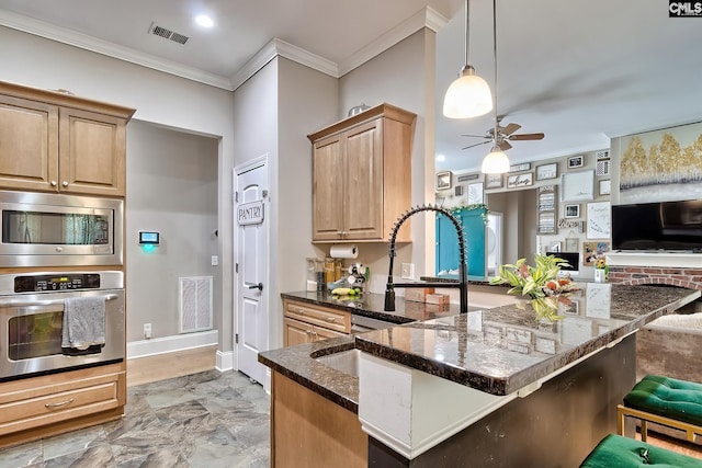 117 Shoal Creek Ln, Blythewood, SC 29016 - kitchen with appliances with stainless steel finishes, crown molding, a ceiling fan, dark stone countertops, and a kitchen breakfast bar