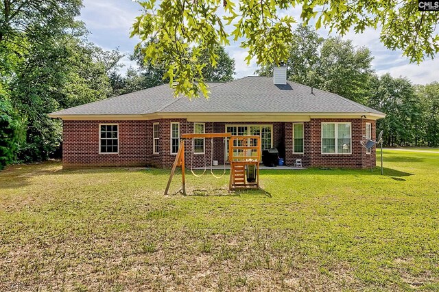 117 Shoal Creek Ln, Blythewood, SC 29016 - back of property with a playground, a chimney, a yard, and brick siding