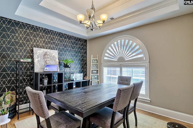 117 Shoal Creek Ln, Blythewood, SC 29016 - dining room with a chandelier, a tray ceiling, crown molding, plenty of natural light, and wood finished floors