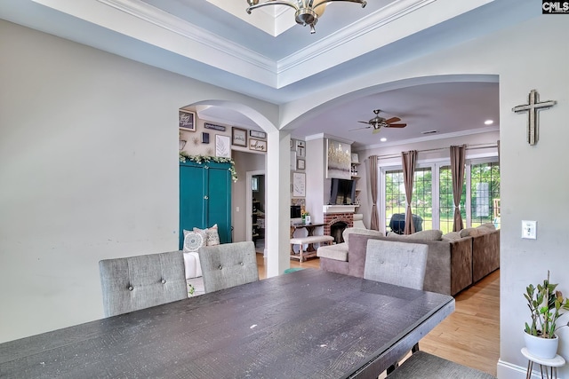 117 Shoal Creek Ln, Blythewood, SC 29016 - dining area with arched walkways, ornamental molding, light wood-style floors, ceiling fan, and a chandelier