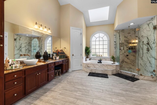 279 Canterwood Rd, Irmo, SC 29063 - bathroom featuring lofted ceiling, a marble finish shower, a garden tub, vanity, and wood finished floors
