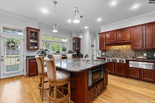 279 Canterwood Rd, Irmo, SC 29063 - kitchen with a warming drawer, built in microwave, light wood finished floors, stainless steel gas cooktop, and ornamental molding