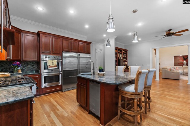 279 Canterwood Rd, Irmo, SC 29063 - kitchen with stainless steel appliances, ornamental molding, a sink, ceiling fan, and light wood finished floors