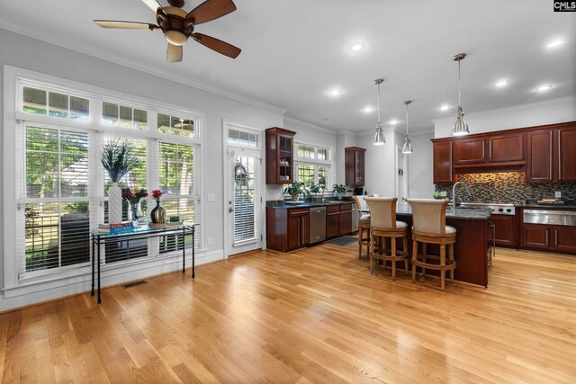 279 Canterwood Rd, Irmo, SC 29063 - kitchen featuring a warming drawer, stainless steel dishwasher, a breakfast bar area, light wood finished floors, and crown molding