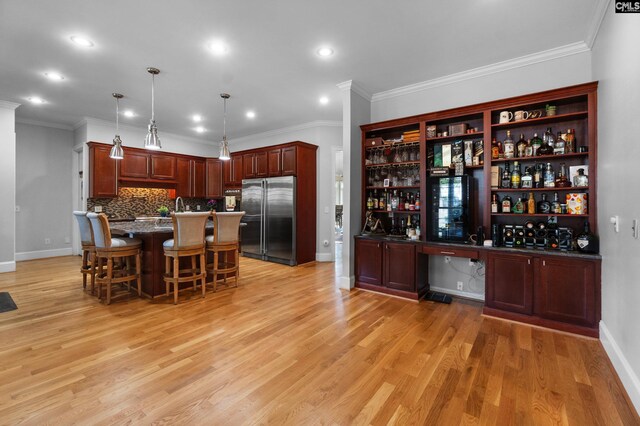 279 Canterwood Rd, Irmo, SC 29063 - kitchen with stainless steel built in fridge, open shelves, a breakfast bar, baseboards, and ornamental molding