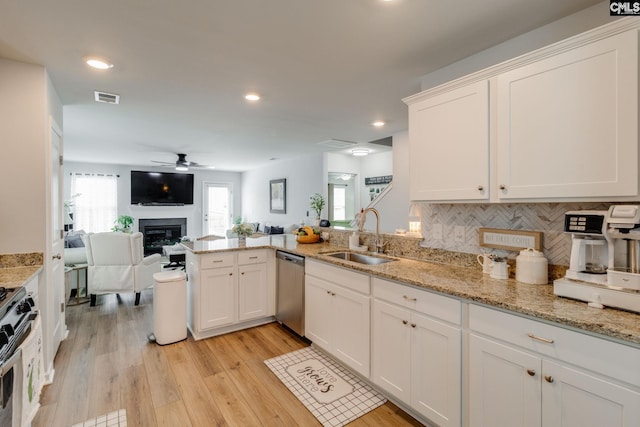 637 Penfolds Way, Blythewood, SC 29016 - kitchen featuring a sink, stainless steel dishwasher, a glass covered fireplace, ceiling fan, and open floor plan