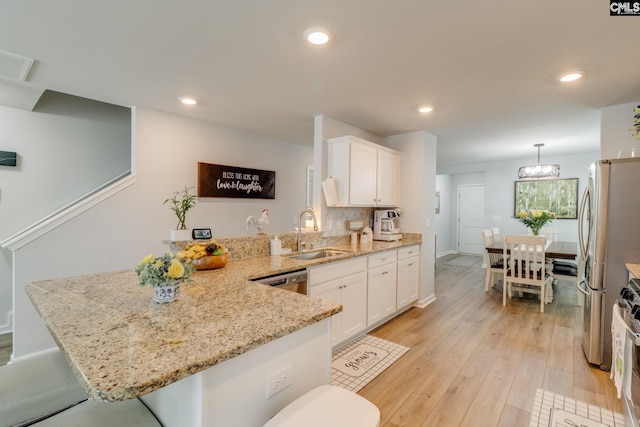 637 Penfolds Way, Blythewood, SC 29016 - kitchen featuring a sink, a peninsula, white cabinetry, light wood-type flooring, and recessed lighting