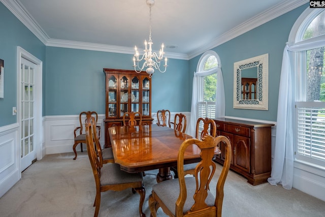 616 Brandon Ct, Lexington, SC 29072 - dining room with light colored carpet, a chandelier, crown molding, and wainscoting