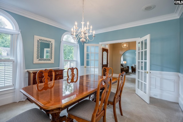 616 Brandon Ct, Lexington, SC 29072 - dining space with french doors, ornamental molding, wainscoting, a chandelier, and arched walkways