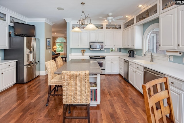 616 Brandon Ct, Lexington, SC 29072 - kitchen with stainless steel appliances, a sink, a ceiling fan, white cabinets, and a breakfast bar area