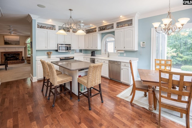 616 Brandon Ct, Lexington, SC 29072 - kitchen with appliances with stainless steel finishes, ceiling fan, white cabinets, ornamental molding, and a kitchen breakfast bar