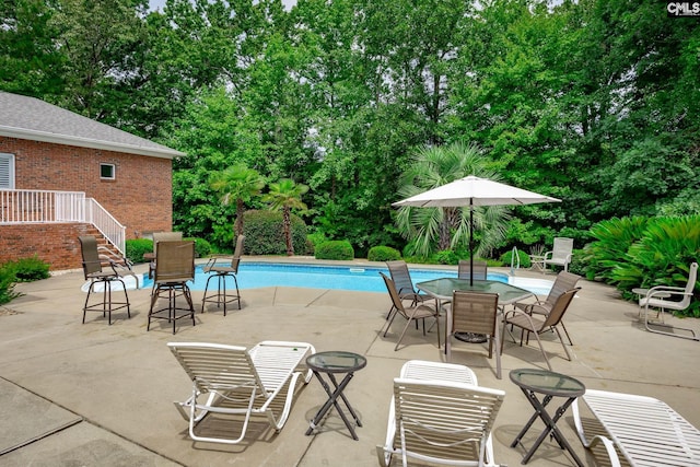 616 Brandon Ct, Lexington, SC 29072 - swimming pool featuring view of scattered trees, a patio area, and outdoor dining space
