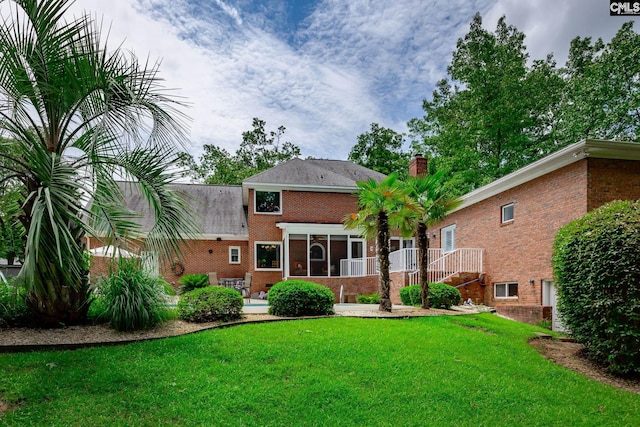 616 Brandon Ct, Lexington, SC 29072 - back of house featuring brick siding, a sunroom, a lawn, and a chimney