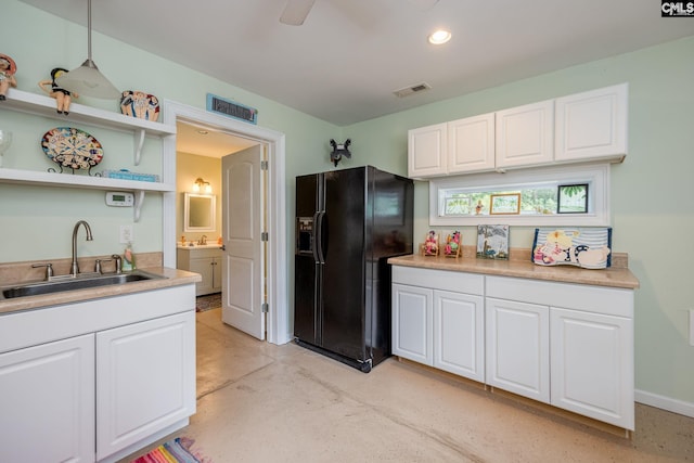616 Brandon Ct, Lexington, SC 29072 - kitchen with black fridge, a sink, white cabinetry, concrete flooring, and light countertops