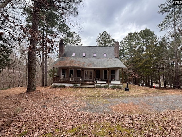 1225 Wateree Rd, Winnsboro, SC 29180 - cape cod house featuring a chimney, a porch, and french doors