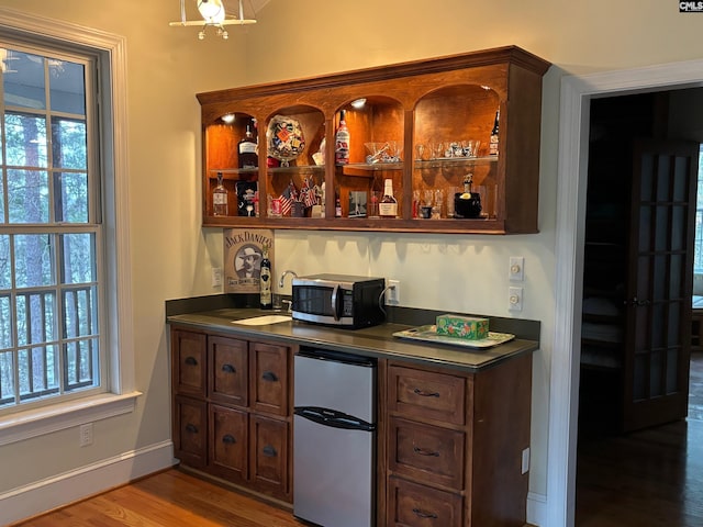 1225 Wateree Rd, Winnsboro, SC 29180 - indoor wet bar featuring appliances with stainless steel finishes, light wood-style flooring, plenty of natural light, and baseboards