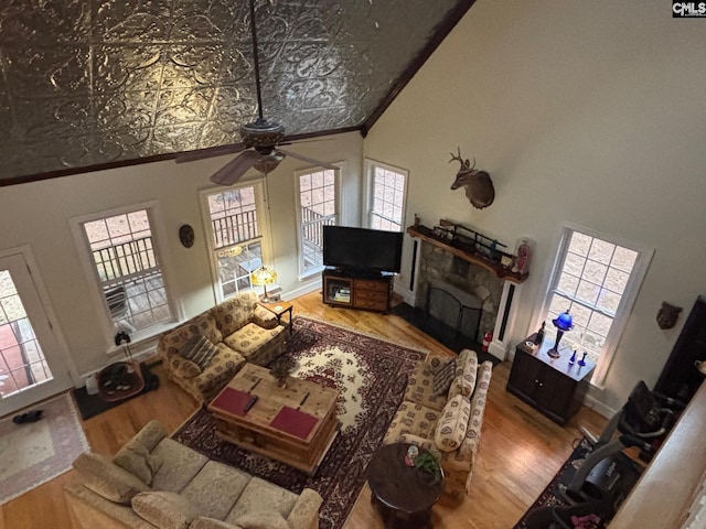 1225 Wateree Rd, Winnsboro, SC 29180 - living room with a ceiling fan, crown molding, wood finished floors, a fireplace, and an ornate ceiling
