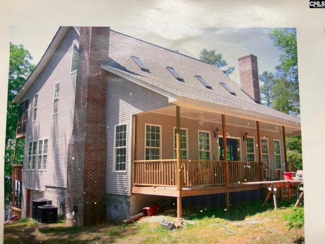 1225 Wateree Rd, Winnsboro, SC 29180 - rear view of house with a chimney, central air condition unit, roof with shingles, and a wooden deck