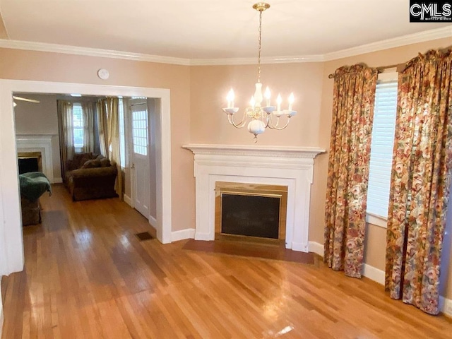 2825 Pruitt Dr, Columbia, SC 29204 - unfurnished living room with a fireplace with flush hearth, wood finished floors, a chandelier, ornamental molding, and baseboards