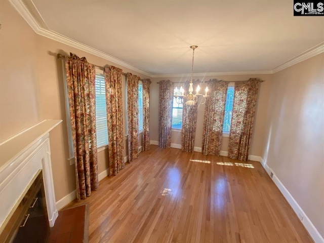 2825 Pruitt Dr, Columbia, SC 29204 - unfurnished dining area featuring a chandelier, light wood finished floors, crown molding, and baseboards