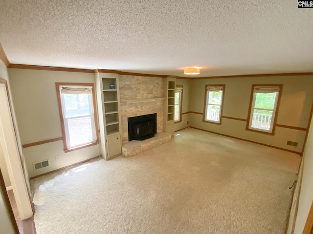 141 Runneymede Dr, Blythewood, SC 29016 - unfurnished living room with carpet, a textured ceiling, crown molding, baseboards, and built in shelves