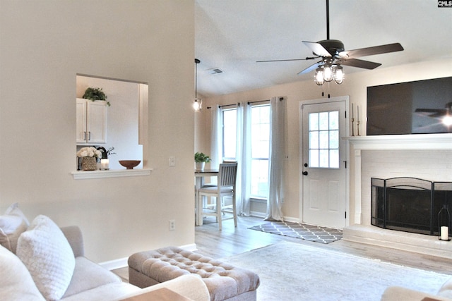 25 Elcock Cir, Irmo, SC 29063 - living area with wood finished floors, a ceiling fan, baseboards, and a brick fireplace