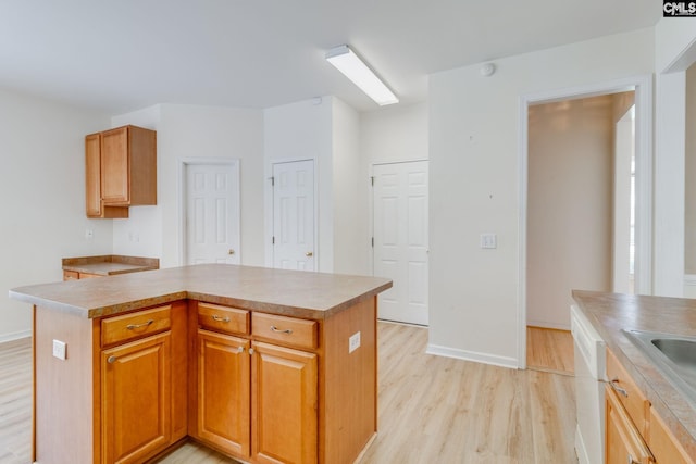 1113 Walden Place Dr, Elgin, SC 29045 - kitchen featuring light wood-style floors, a center island, baseboards, and light countertops