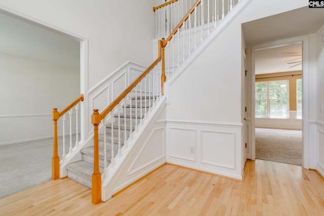 1113 Walden Place Dr, Elgin, SC 29045 - staircase with a decorative wall, wood finished floors, and wainscoting
