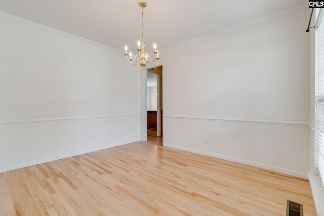 1113 Walden Place Dr, Elgin, SC 29045 - empty room featuring a chandelier, wood finished floors, ornamental molding, and baseboards