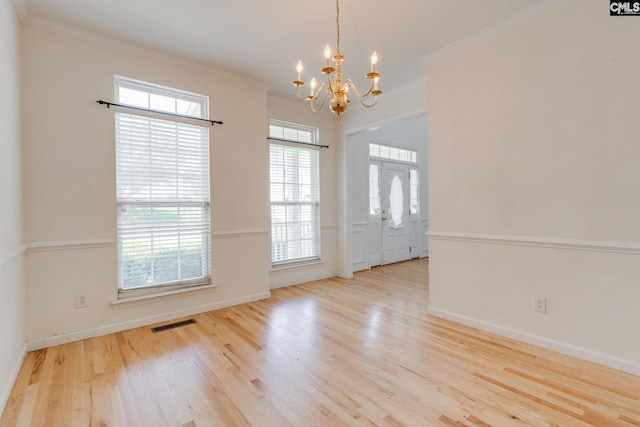 1113 Walden Place Dr, Elgin, SC 29045 - spare room featuring a chandelier, wood finished floors, crown molding, and baseboards