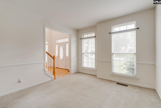 1113 Walden Place Dr, Elgin, SC 29045 - carpeted empty room featuring plenty of natural light, baseboards, and stairway