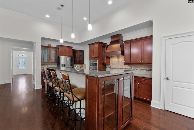 135 Bay Wren Rd, Blythewood, SC 29016 - kitchen with custom exhaust hood, stainless steel fridge, dark wood-style floors, a kitchen breakfast bar, and tasteful backsplash