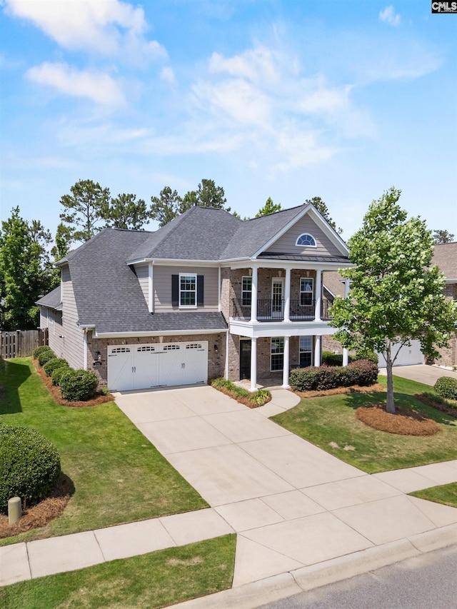 135 Bay Wren Rd, Blythewood, SC 29016 - neoclassical home featuring a balcony, brick siding, concrete driveway, a shingled roof, and a garage