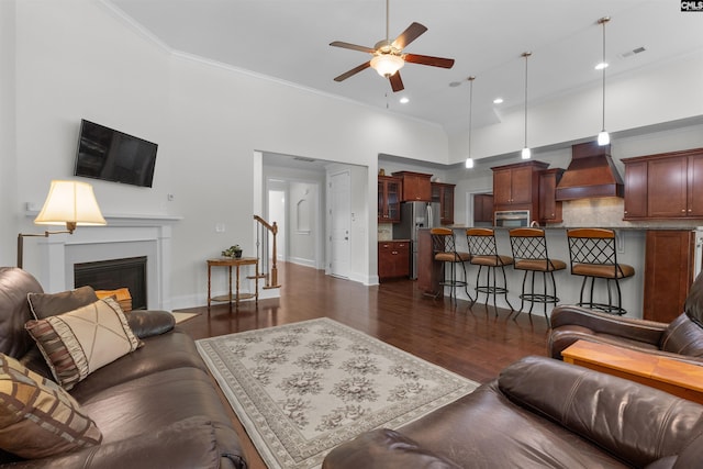 135 Bay Wren Rd, Blythewood, SC 29016 - living room featuring a ceiling fan, ornamental molding, dark wood finished floors, recessed lighting, and a glass covered fireplace