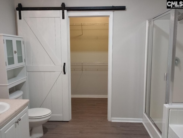 1699 Green Hill Rd, Lugoff, SC 29078 - bathroom featuring wood finished floors, a stall shower, toilet, and a spacious closet