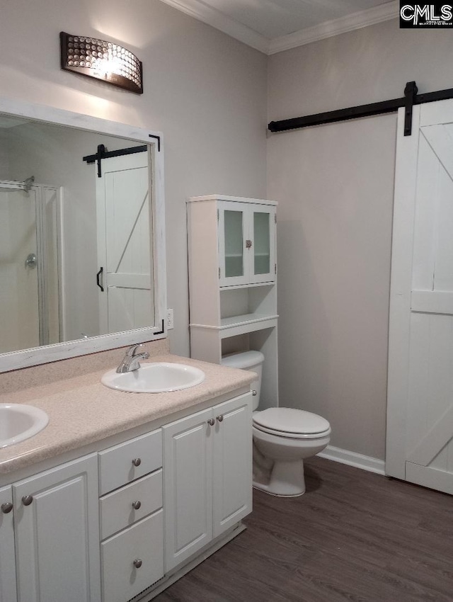 1699 Green Hill Rd, Lugoff, SC 29078 - full bathroom featuring ornamental molding, double vanity, a shower stall, wood finished floors, and toilet