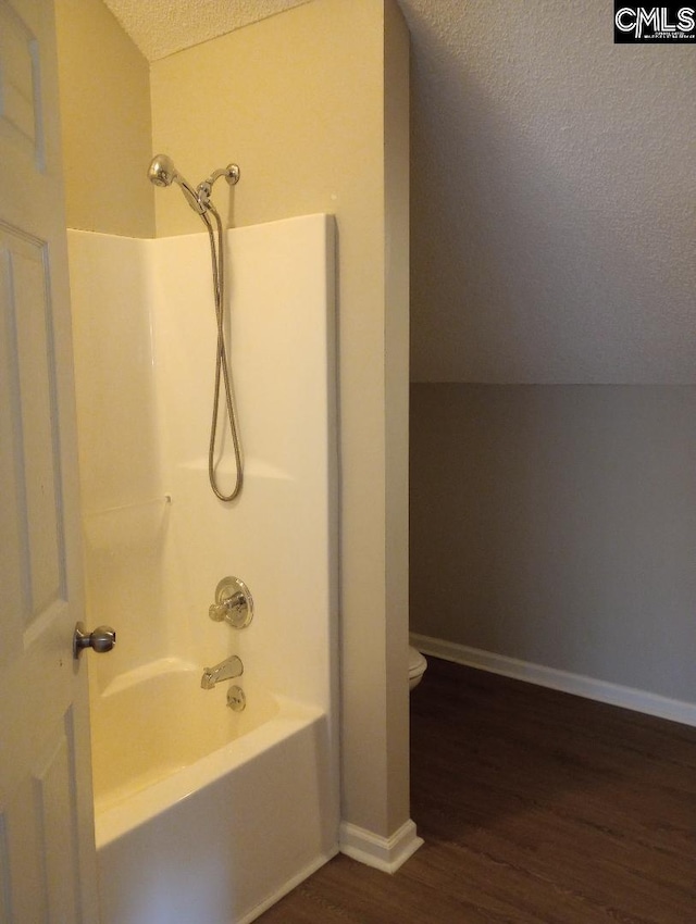 1699 Green Hill Rd, Lugoff, SC 29078 - full bath featuring wood finished floors, a textured ceiling, shower / washtub combination, toilet, and baseboards