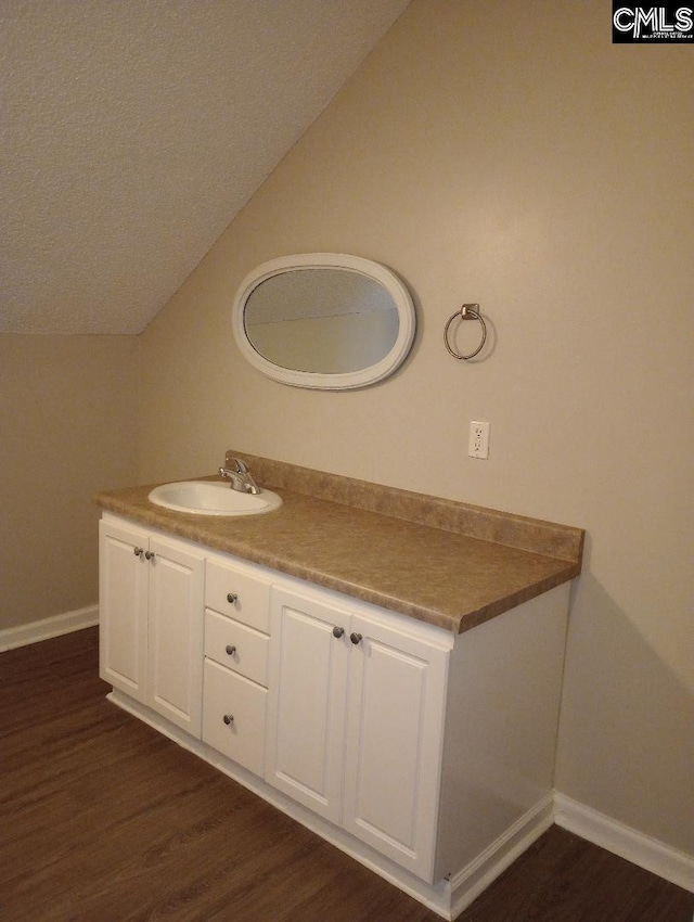 1699 Green Hill Rd, Lugoff, SC 29078 - bathroom with vaulted ceiling, wood finished floors, baseboards, and vanity