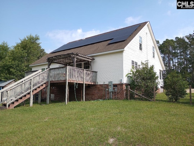 1699 Green Hill Rd, Lugoff, SC 29078 - back of property with stairs, roof mounted solar panels, a pergola, and a lawn