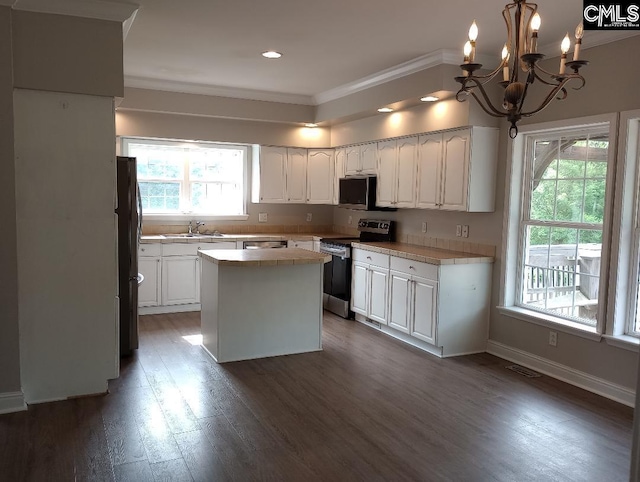 1699 Green Hill Rd, Lugoff, SC 29078 - kitchen with appliances with stainless steel finishes, ornamental molding, white cabinets, dark wood-type flooring, and a kitchen island