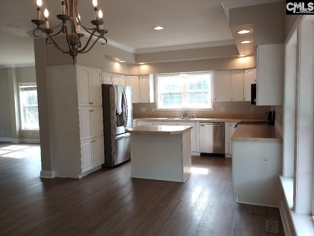 1699 Green Hill Rd, Lugoff, SC 29078 - kitchen featuring appliances with stainless steel finishes, light countertops, dark wood-style flooring, ornamental molding, and white cabinetry