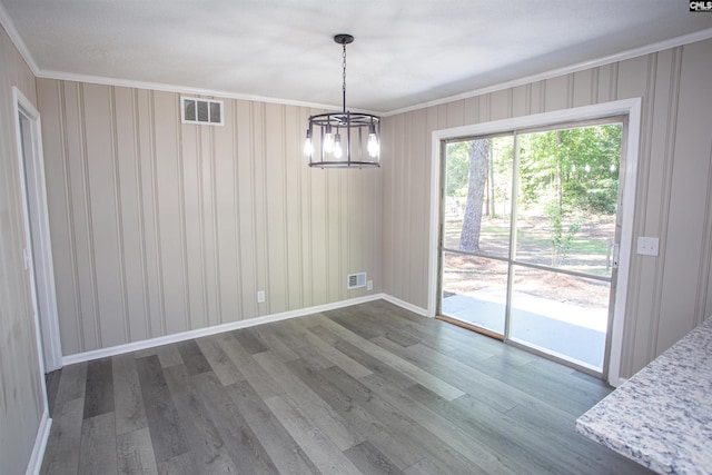4513 Bonnie Forest Blvd, Columbia, SC 29210 - unfurnished dining area featuring crown molding, a chandelier, wood finished floors, and baseboards