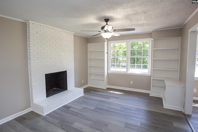 4513 Bonnie Forest Blvd, Columbia, SC 29210 - unfurnished living room with ceiling fan, crown molding, dark wood-style floors, a textured ceiling, and a brick fireplace