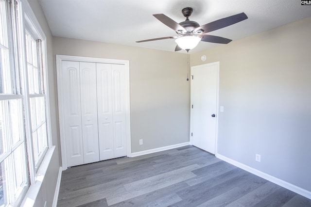 4513 Bonnie Forest Blvd, Columbia, SC 29210 - unfurnished bedroom featuring wood finished floors, a closet, baseboards, and a ceiling fan